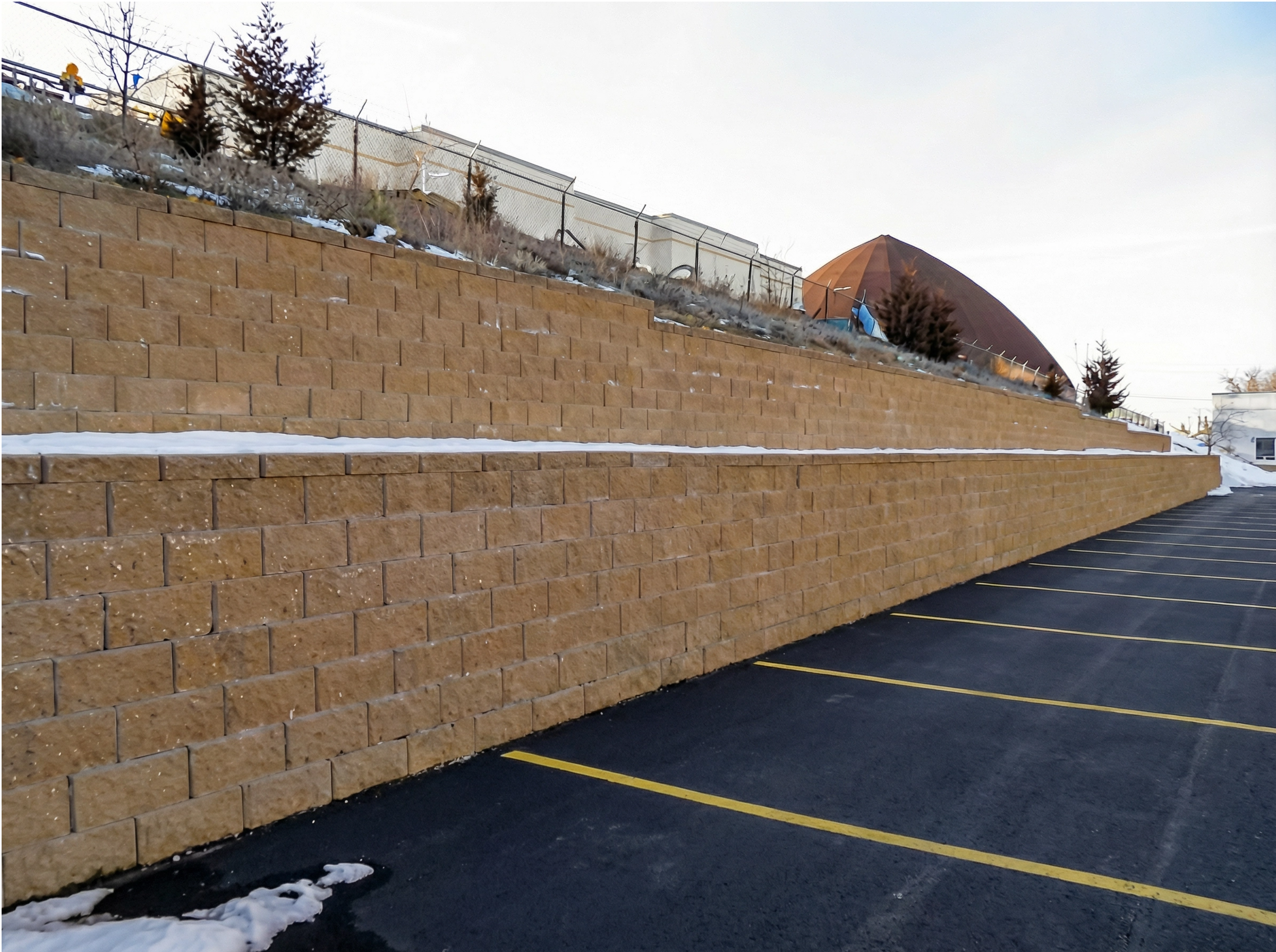 Commercial retaining wall system for parking lot grade change